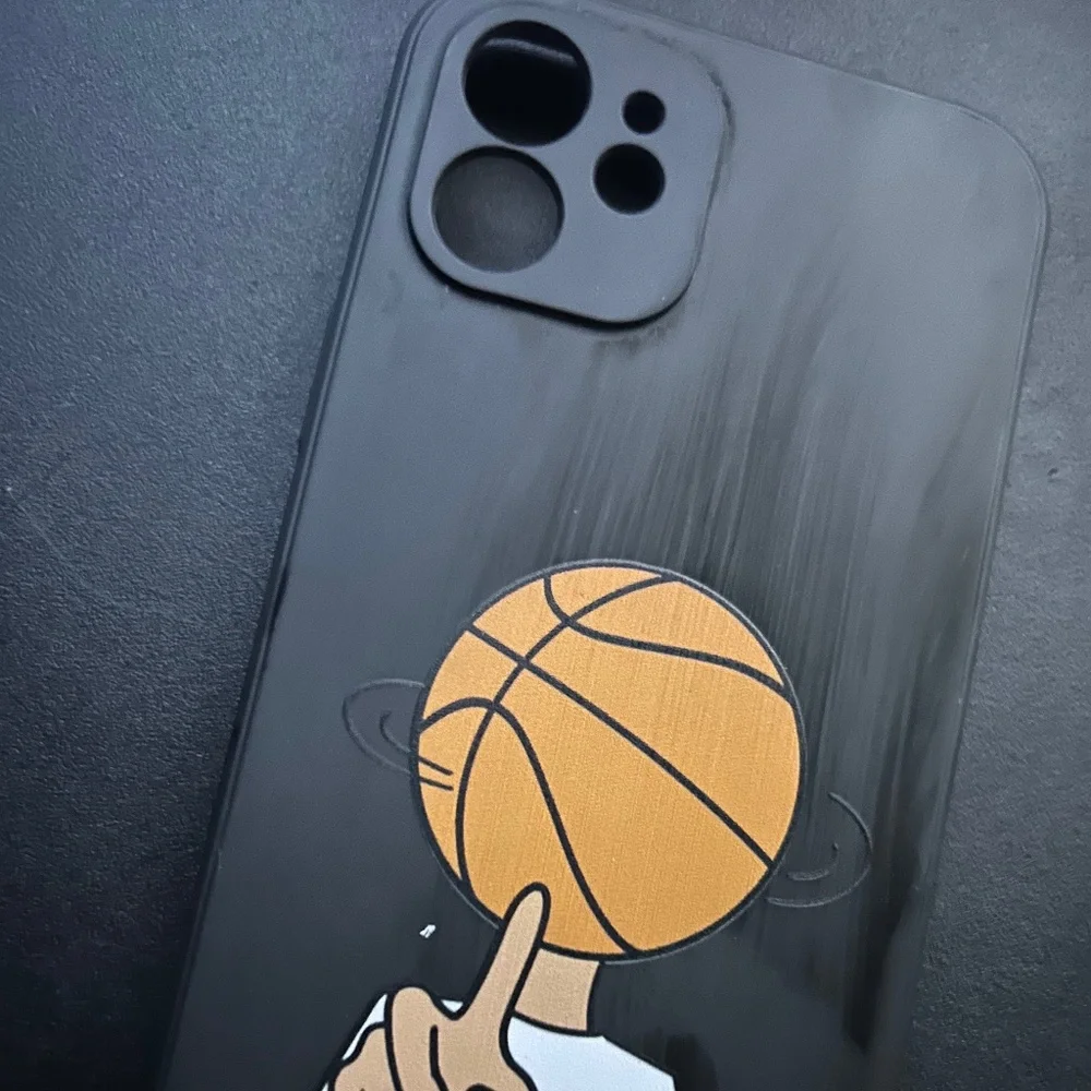 Person spinning basketball on hand phone case